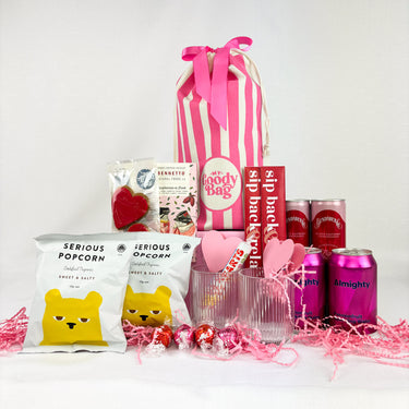 Pink Goody Bag filled with treats, popcorn, drinks, glasses