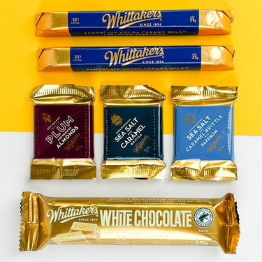 Whittaker's chocolate bars and packets on a yellow and white background