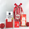 Red My Goody Bag surrounded with coffee, luxury christmas cake and a mug on top of its box which can be personalised through a printing service within My Goody Bag.
