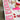 A white table displays a Valentine's Day gift bundle including pink and white striped gift bags, red heart candies, pink ribbons, and a box of lip glosses.