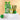 pineapple bits colada alcoholic drink with reeded glass and kiwi artisan olives flank green striped goody bag against gold background by My Goody Bag