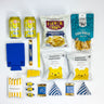 Assorted snacks and drinks including cans, popcorn bags, and chips on a white background