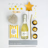 Gift set with mini bottle of Freixenet, chocolate candies, and decorative items on a white background