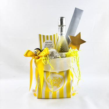Decorative goodie bag with a bottle, star, and striped bag on a white background
