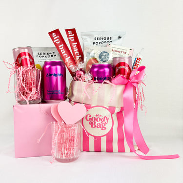 Pink Gift bag filled with various drinks and treats. Ideal for sharing.